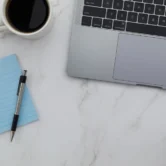 Minimal laptop workspace for designing a brochure