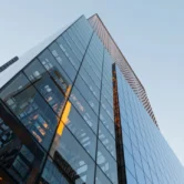 Modern glass office building against the sky