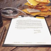 Printed sales document on a desk with reading glasses