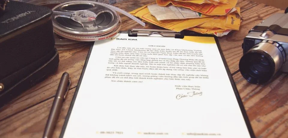Printed sales document on a desk with reading glasses