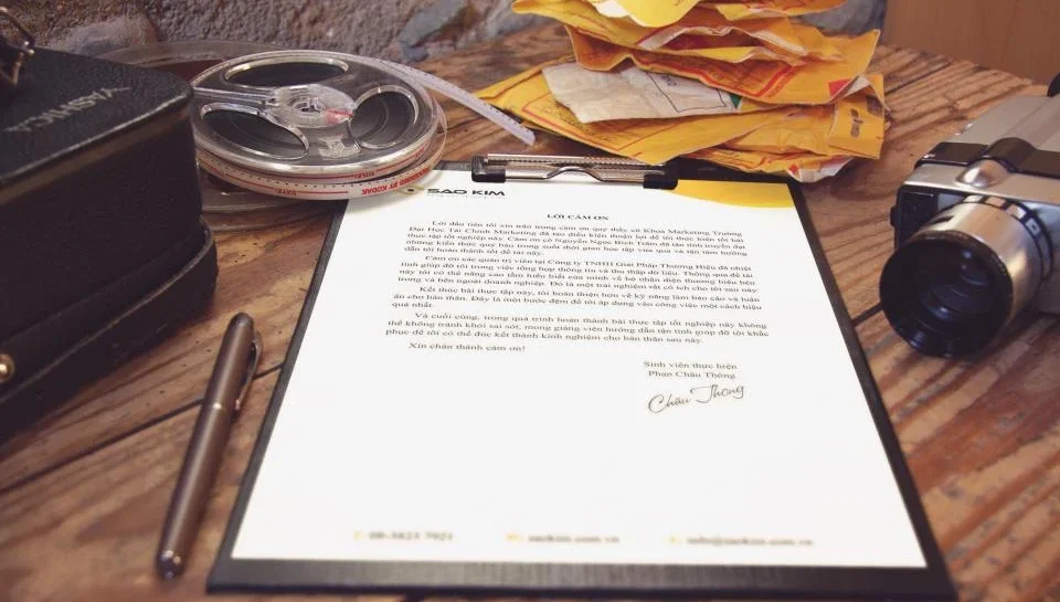 Printed sales document on a desk with reading glasses