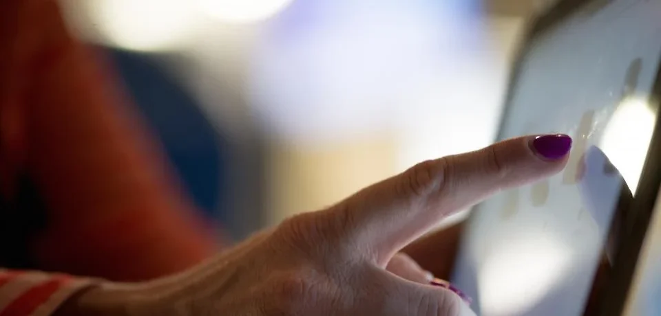 Smartphone showing a home listing next to a laptop displaying a 3D virtual tour walkthrough