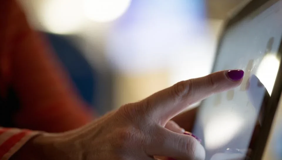 Smartphone showing a home listing next to a laptop displaying a 3D virtual tour walkthrough